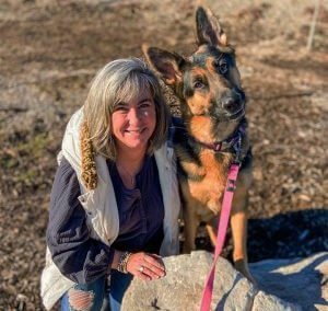 person and dog posing in nature