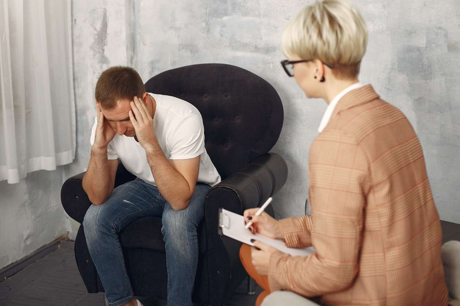 man-sitting-psychologist-s-office-talking-about depression therapy